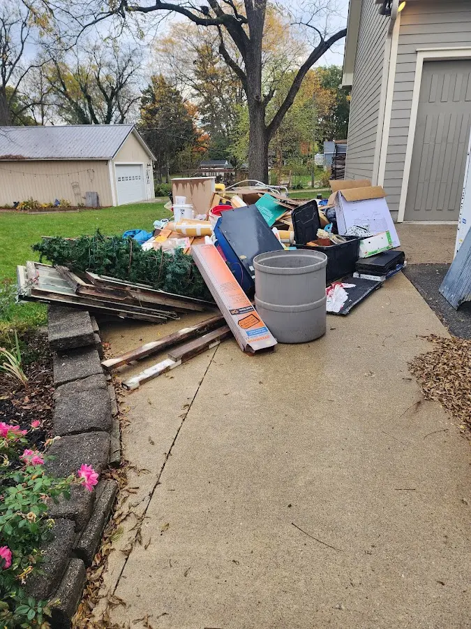 Dumpster being loaded with debris for Demolition Dumpster Rental in Davenport